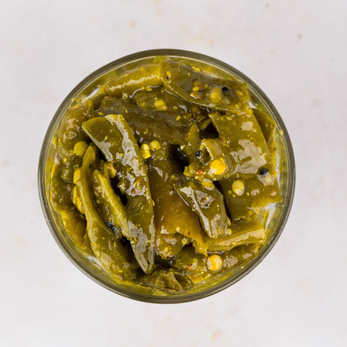 Hari Mirch ka Achaar or Spicy Green Chilli Pickle is prepared using a North Indian style pickle recipe where fresh green chillies are pickled with mustard seeds and other homegrown spices